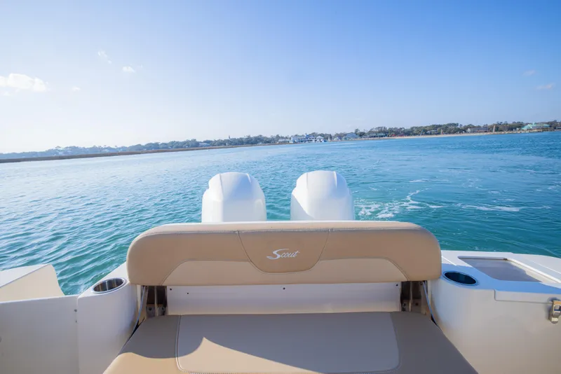 Slide: The Image of 2021 Scout 277 LXF boat on calm water, rear view with twin engines. - 17