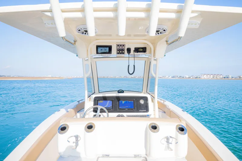 Slide: The Image of 2021 Scout 277 LXF boat dashboard with ocean view and modern navigation equipment. - 22