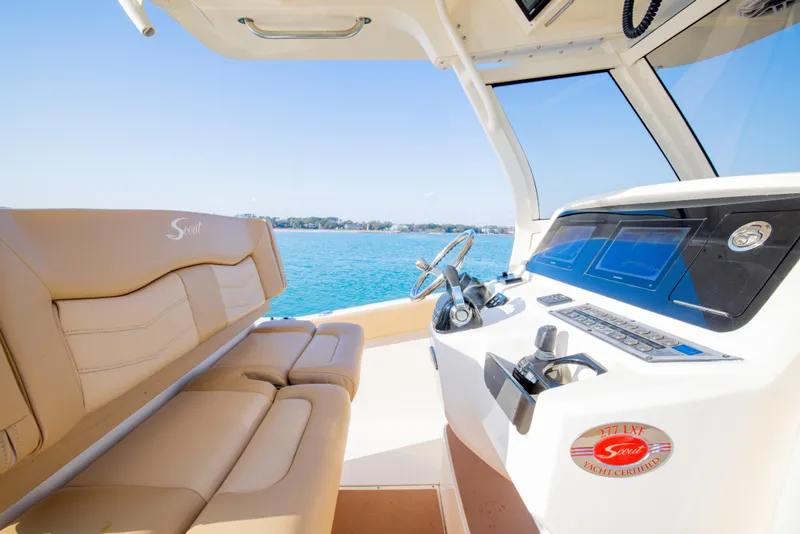 Slide: The Image of 2021 Scout 277 LXF boat interior with modern dashboard and seating. - 31