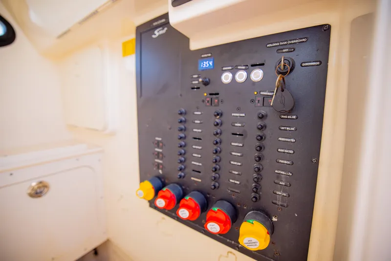 Slide: The Image of Control panel of a 2021 Scout 277 LXF boat with switches and indicators. - 34