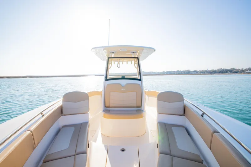 Slide: The Image of 2021 Scout 277 LXF boat on calm water, featuring spacious seating and modern design. - 42