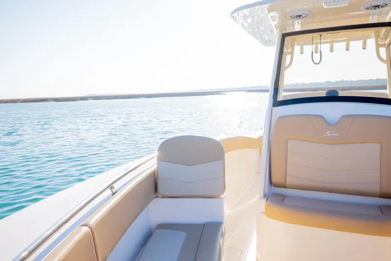 Slide: The Image of 2021 Scout 277 LXF boat interior with seating, on calm water. - 43