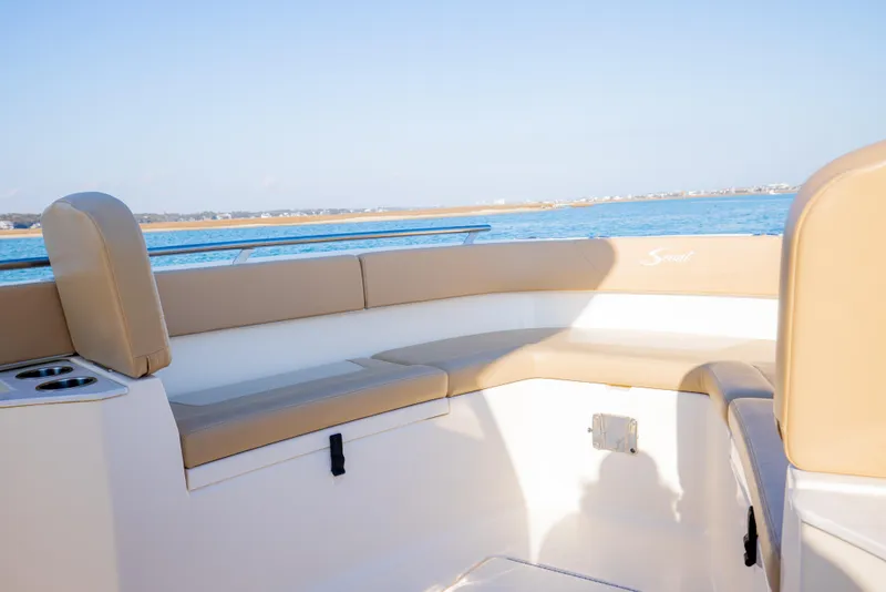 Slide: The Image of 2021 Scout 277 LXF boat interior with tan seating and ocean view. - 47
