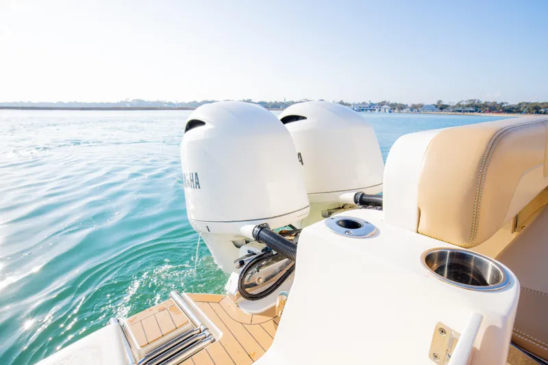 Slide: The Image of 2021 Scout 277 LXF boat with dual Yamaha outboard engines on calm water. - 48