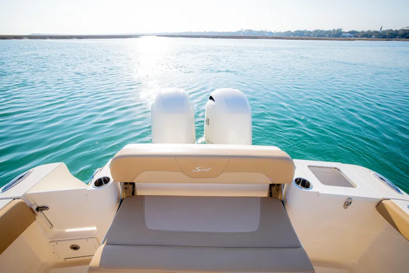 Slide: The Image of 2021 Scout 277 LXF boat with dual engines on calm water. - 49