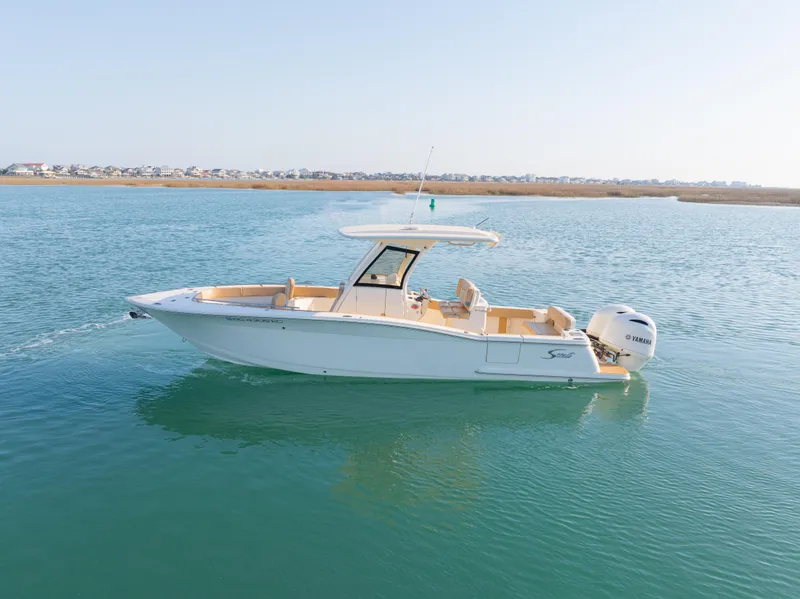 Slide: The Image of 2021 Scout 277 LXF boat on calm water, side view. - 6