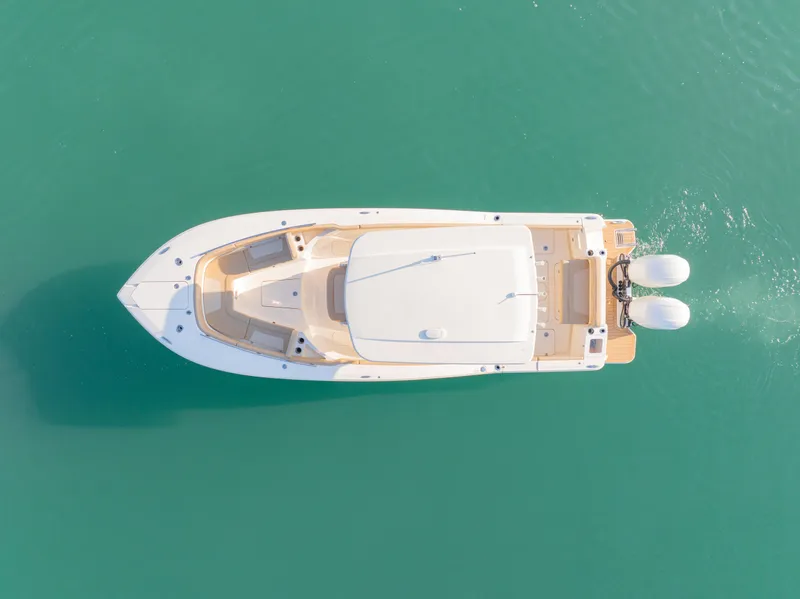 Slide: The Image of Aerial view of 2021 Scout 277 LXF boat on turquoise water. - 8