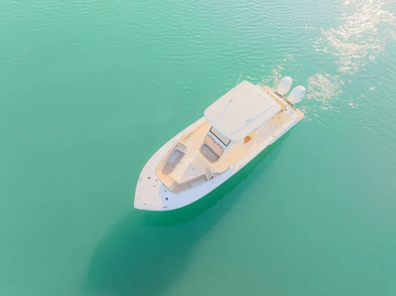 Slide: The Image of 2021 Scout 277 LXF boat on turquoise water, aerial view. - 9