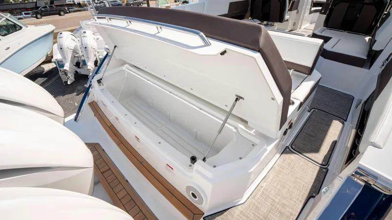 Slide: The Image of Open storage compartment on 2025 Cobalt R33 boat, showcasing spacious interior and seating area. - 13