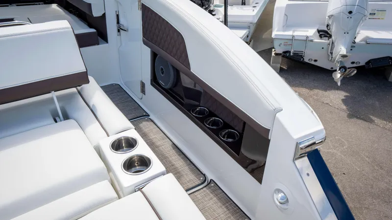 Slide: The Image of Luxury seating area on 2025 Cobalt R33 boat with cup holders and speaker. - 15