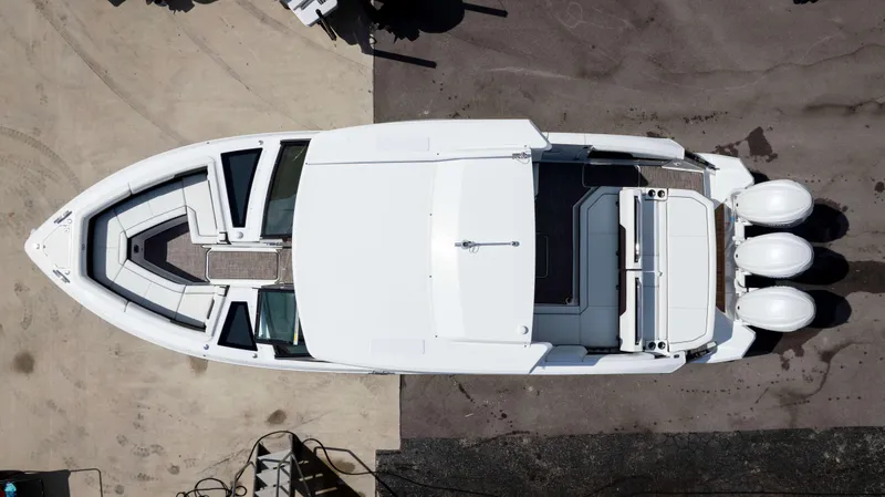 Slide: The Image of Aerial view of 2025 Cobalt R33 boat with triple engines, docked on concrete. - 4