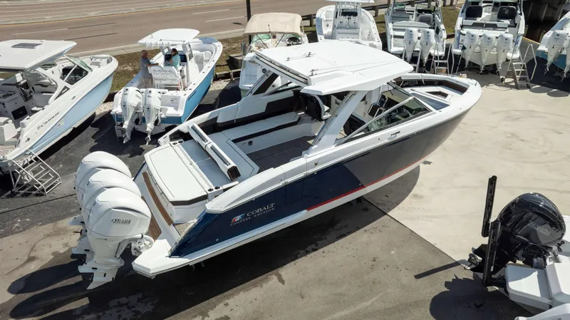Slide: The Image of 2025 Cobalt R33 boat with Yamaha engines, displayed in a marina setting. - 5