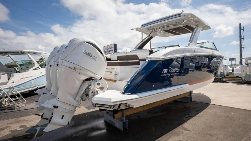 Slide: The Image of 2025 Cobalt R33 boat with Yamaha engines on display at a marina. - 7