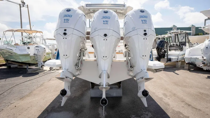 Slide: The Image of Triple Yamaha 300 V6 outboard engines on a 2025 Cobalt R33 boat, parked outdoors. - 8