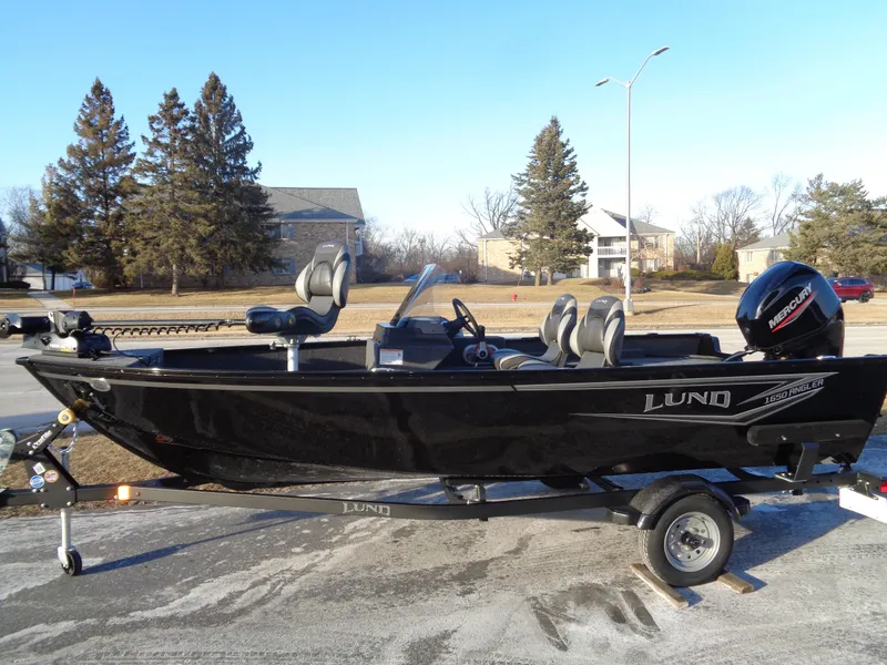 The Image of 2025 Lund 1650 Angler SS boat on trailer, parked outdoors. - 0