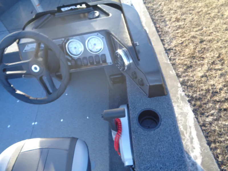 Slide: The Image of 2025 Lund 1650 Angler SS boat dashboard with steering wheel and gauges. - 10