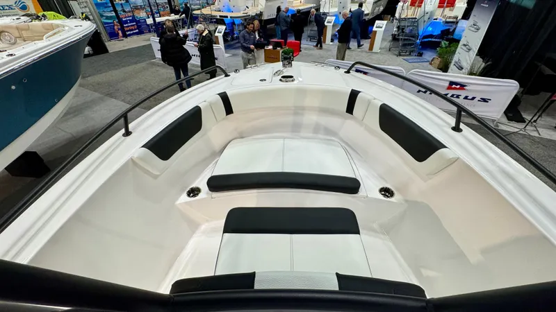 Slide: The Image of 2025 Edgewater 208CC Watchman boat interior at a boat show display. - 8