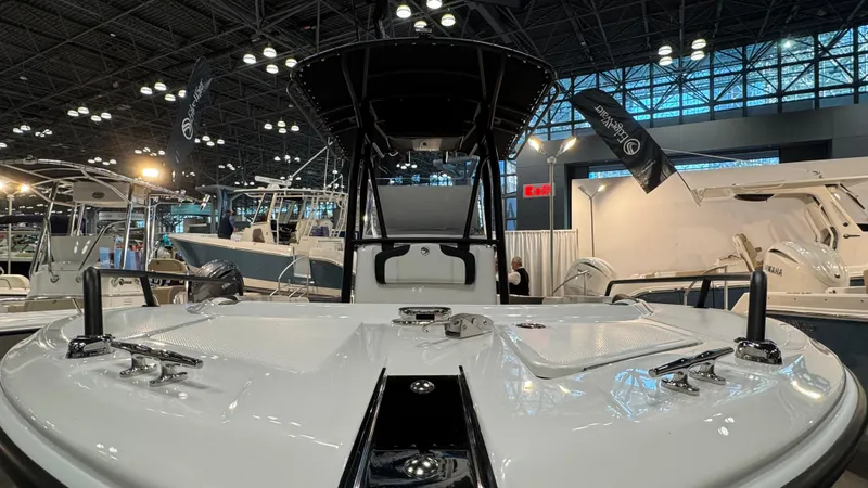 Slide: The Image of 2025 Edgewater 208CC Watchman boat showcased at an indoor exhibition. - 9
