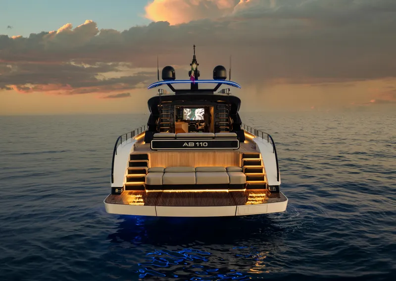 Slide: The Image of Luxury yacht AB 110, 2026 model, illuminated at sunset on open sea. - 5