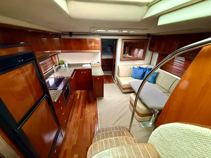 Slide: The Image of Luxurious interior of 2006 Sea Ray 48 Sundancer yacht with modern kitchen and seating area. - 13