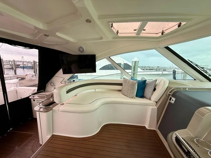 Slide: The Image of Luxurious interior of 2006 Sea Ray 48 Sundancer yacht with plush seating and TV. - 14