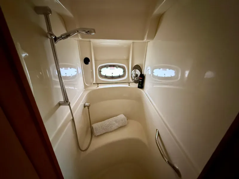 Slide: The Image of Luxurious bathroom in 2006 Sea Ray 48 Sundancer yacht with shower and porthole window. - 15