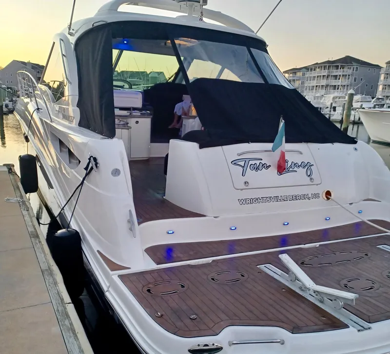 Slide: The Image of 2006 Sea Ray 48 Sundancer yacht docked at sunset, featuring a sleek design and spacious deck. - 35