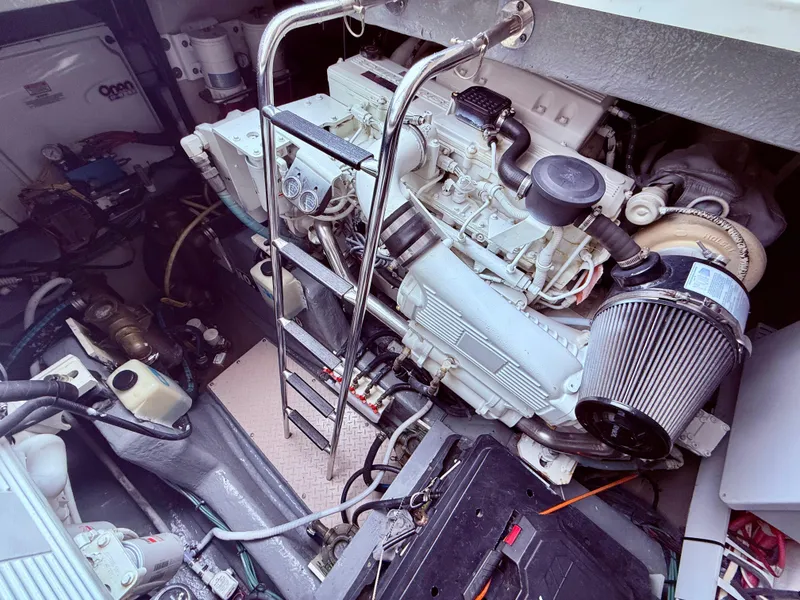 Slide: The Image of Engine room of 2006 Sea Ray 48 Sundancer with visible machinery and ladder. - 39