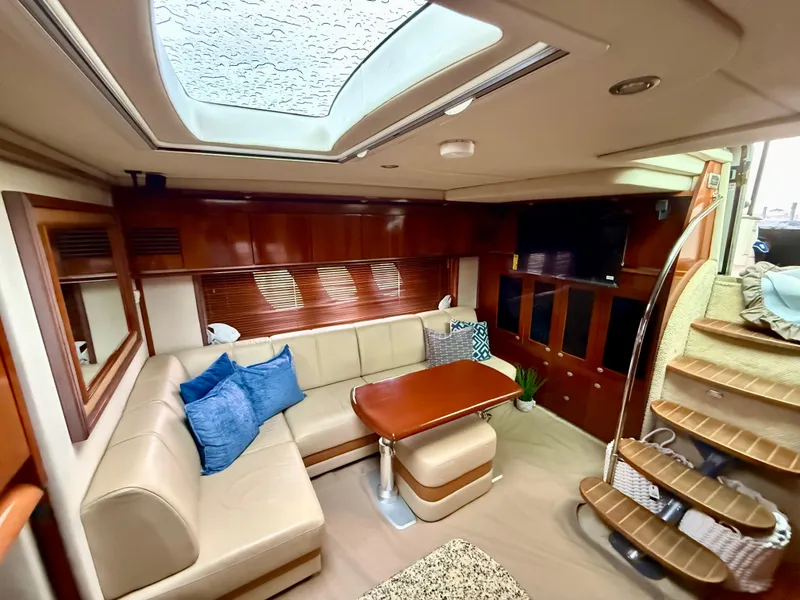 Slide: The Image of Interior view of 2006 Sea Ray 48 Sundancer yacht cockpit with plush seating and control panel. - 4