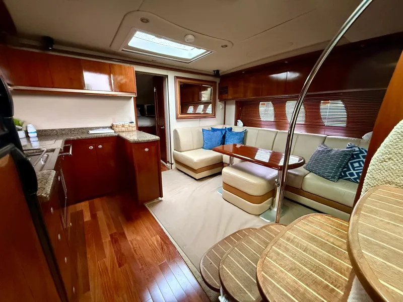 Slide: The Image of 2006 Sea Ray 48 Sundancer yacht docked in a marina under cloudy skies. - 5