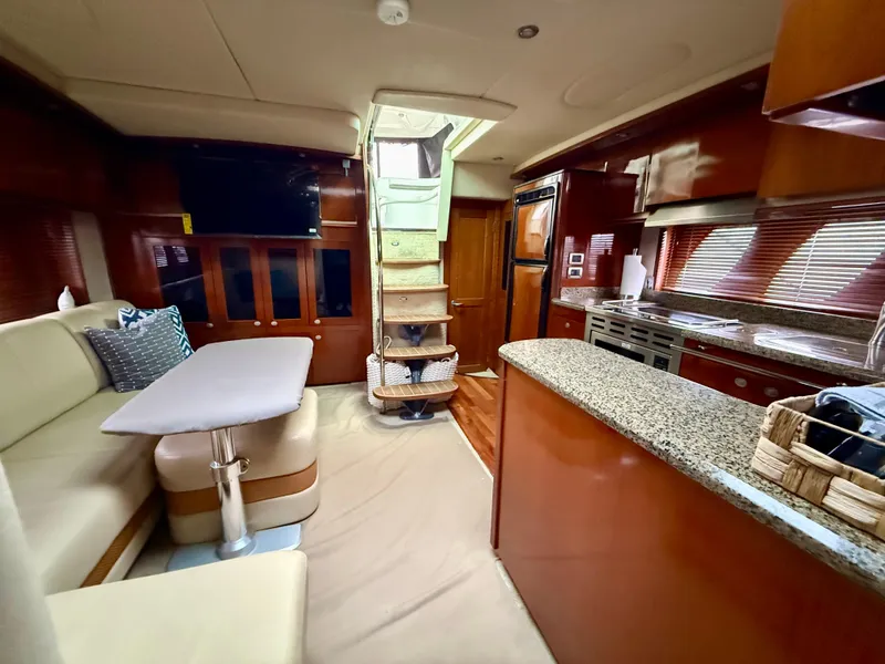 Slide: The Image of Luxurious interior of 2006 Sea Ray 48 Sundancer yacht with modern kitchen and seating area. - 6