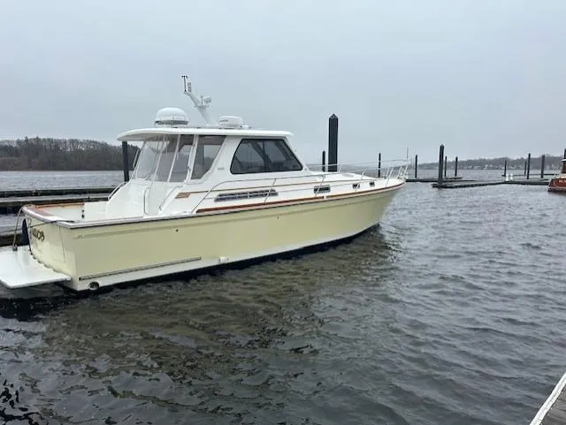Slide: The Image of 2004 Sabre 42 Express Hardtop boat docked on a cloudy day. - 11