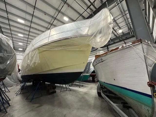 Slide: The Image of 2004 Sabre 42 Express Hardtop boat stored indoors, covered with protective plastic. - 15