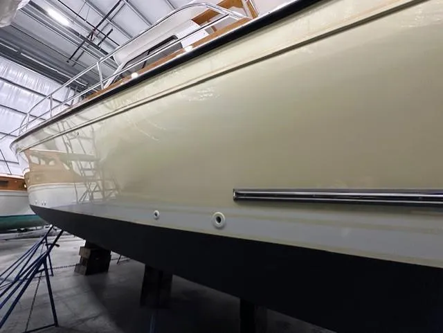 Slide: The Image of 2004 Sabre 42 Express Hardtop boat in storage, side view showing sleek design. - 16