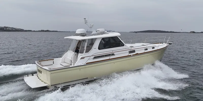 Slide: The Image of 2004 Sabre 42 Express Hardtop cruising on open water. - 2