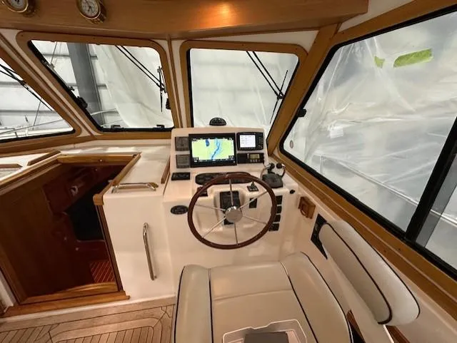 Slide: The Image of 2004 Sabre 42 Express Hardtop helm with navigation equipment and wooden accents. - 24
