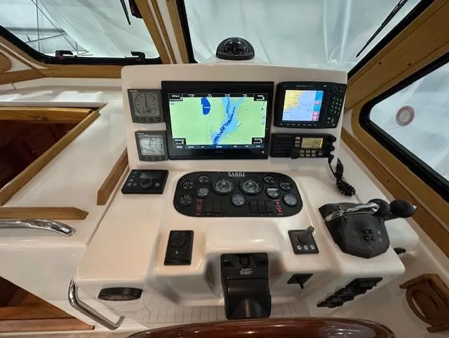Slide: The Image of 2004 Sabre 42 Express Hardtop helm with navigation screens and controls. - 25