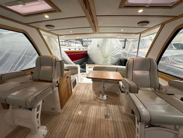 Slide: The Image of 2004 Sabre 42 Express Hardtop interior with leather seating and wooden flooring. - 26