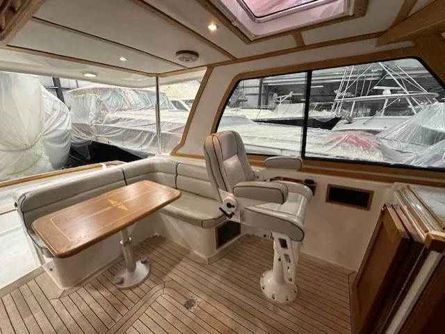 Slide: The Image of 2004 Sabre 42 Express Hardtop interior with seating and table in a boat cabin. - 28
