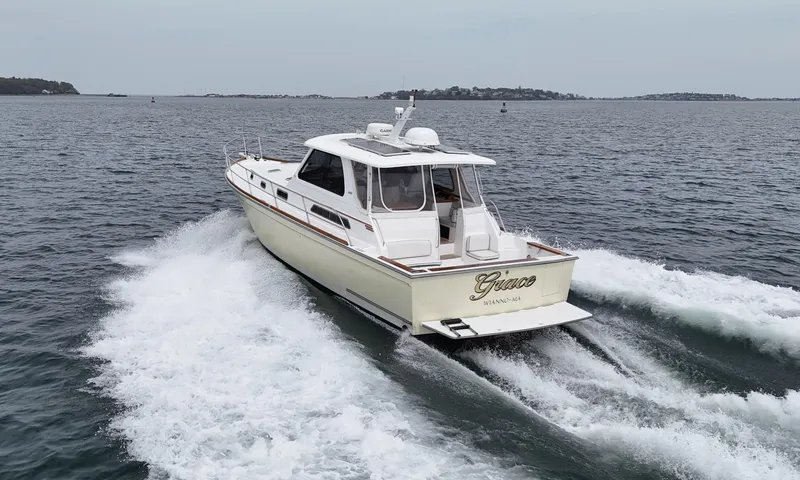Slide: The Image of 2004 Sabre 42 Express Hardtop cruising on open water, rear view. - 3