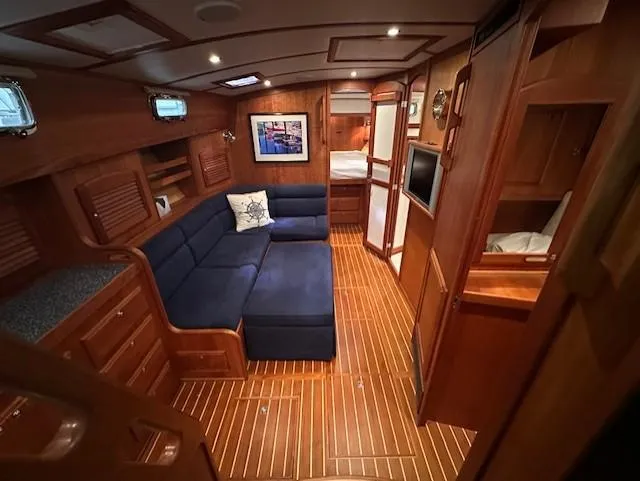Slide: The Image of Luxurious interior of 2004 Sabre 42 Express Hardtop yacht with wooden finish and blue seating. - 31