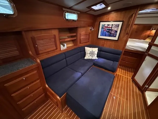 Slide: The Image of 2004 Sabre 42 Express Hardtop interior with blue seating and wooden cabinetry. - 32