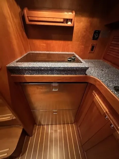 Slide: The Image of 2004 Sabre 42 Express Hardtop interior with wooden cabinetry and granite countertop. - 35