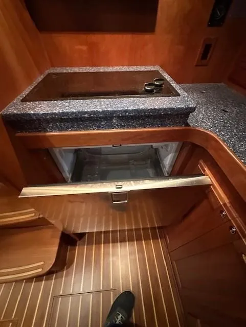 Slide: The Image of 2004 Sabre 42 Express Hardtop interior with open drawer and wooden flooring. - 36