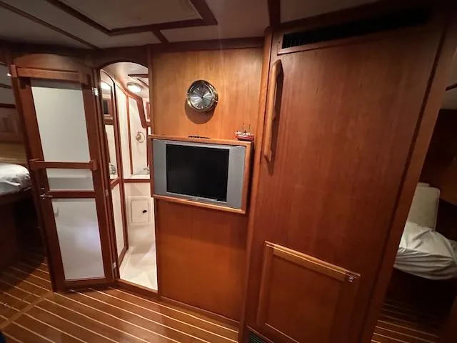 Slide: The Image of Interior of 2004 Sabre 42 Express Hardtop with wood paneling and mounted TV. - 37