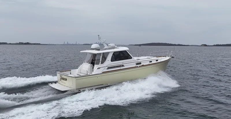Slide: The Image of 2004 Sabre 42 Express Hardtop cruising on open water. - 4