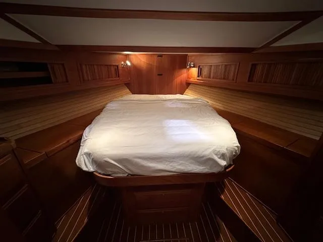 Slide: The Image of 2004 Sabre 42 Express Hardtop cabin with cozy bed and wooden interior. - 41