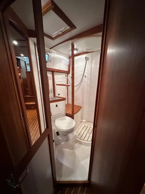 Slide: The Image of 2004 Sabre 42 Express Hardtop yacht bathroom with wooden accents and shower. - 44