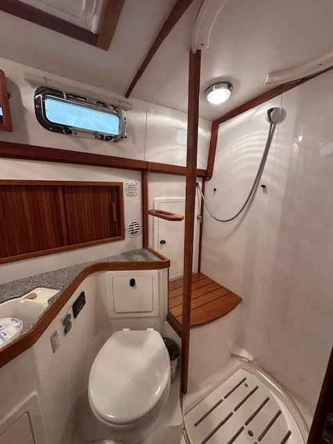 Slide: The Image of 2004 Sabre 42 Express Hardtop yacht bathroom with shower and wooden accents. - 46