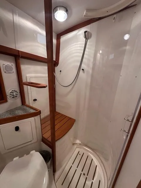 Slide: The Image of 2004 Sabre 42 Express Hardtop yacht bathroom with shower and wooden accents. - 47